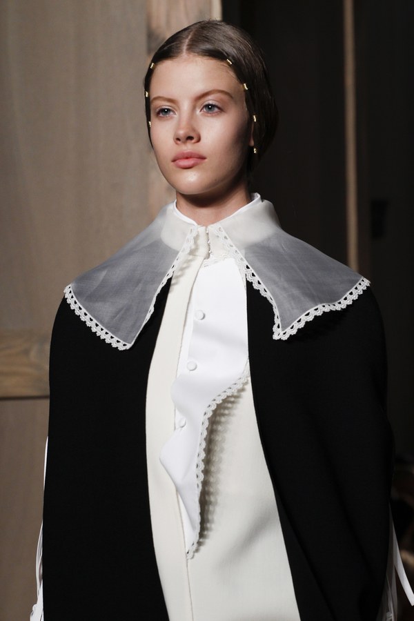 Detail of garment featuring sheer Flemish inspired collar with lace trim