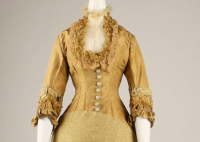 1876-77 – Brass-colored silk day dress