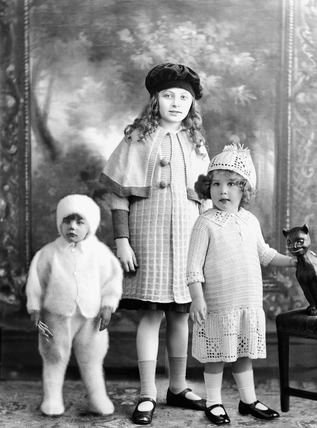 Montage showing three children modelling knitwear: 1920s