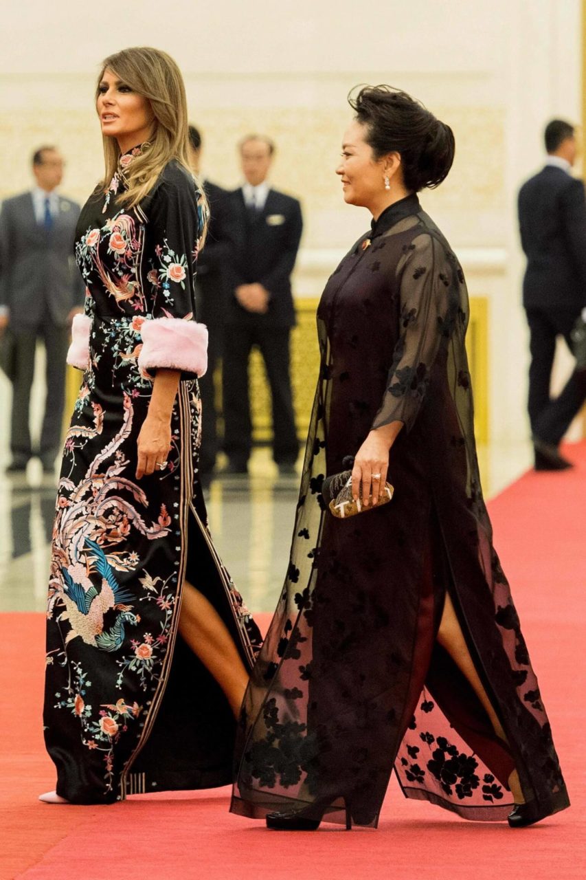 US First Lady Melania Trump walks with Peng Liyuan (right), wife of China's President Xi Jinping, in the Great Hall of the People in Beijing