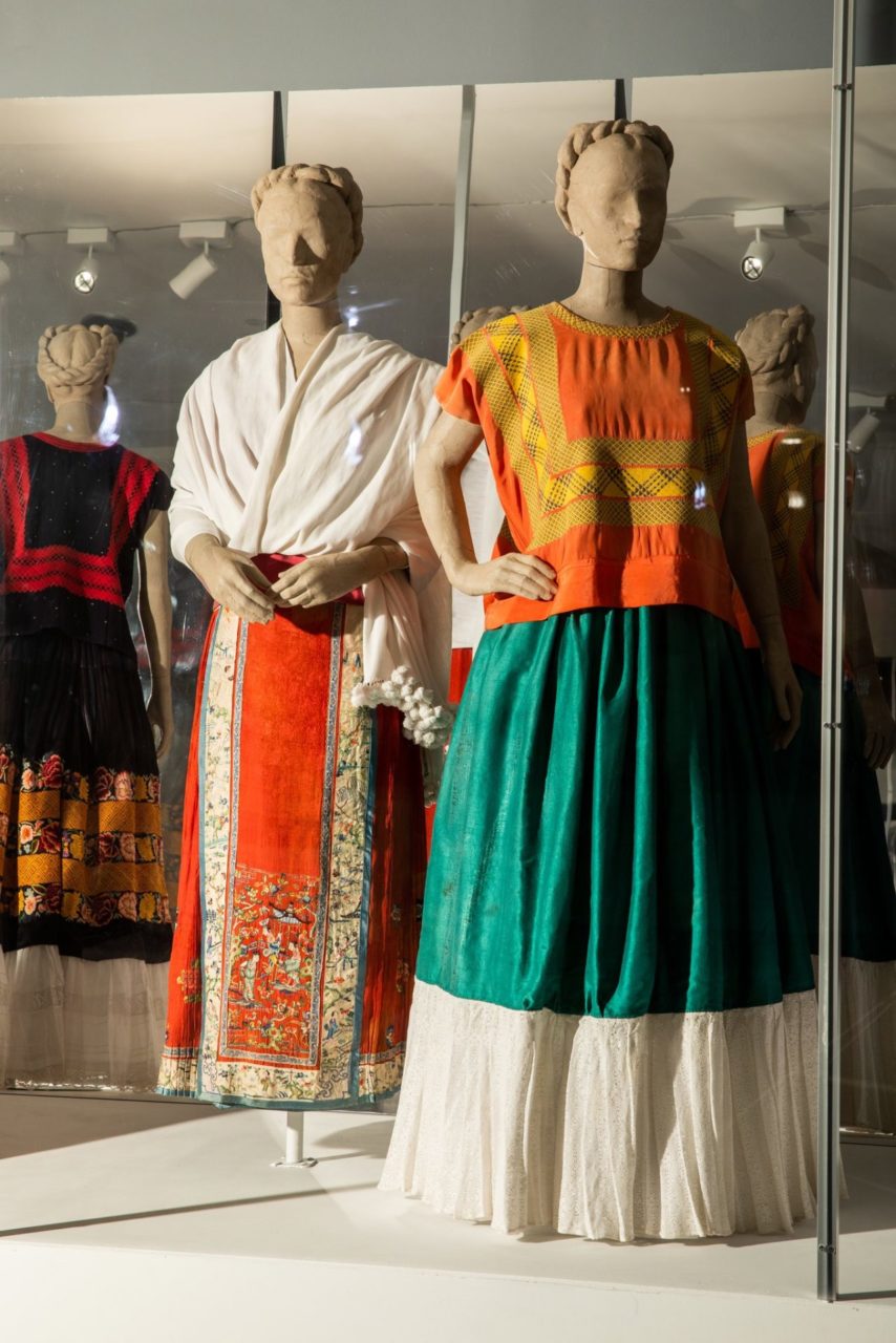 At left, a white shawl paired with a skirt with a Chinese pattern.