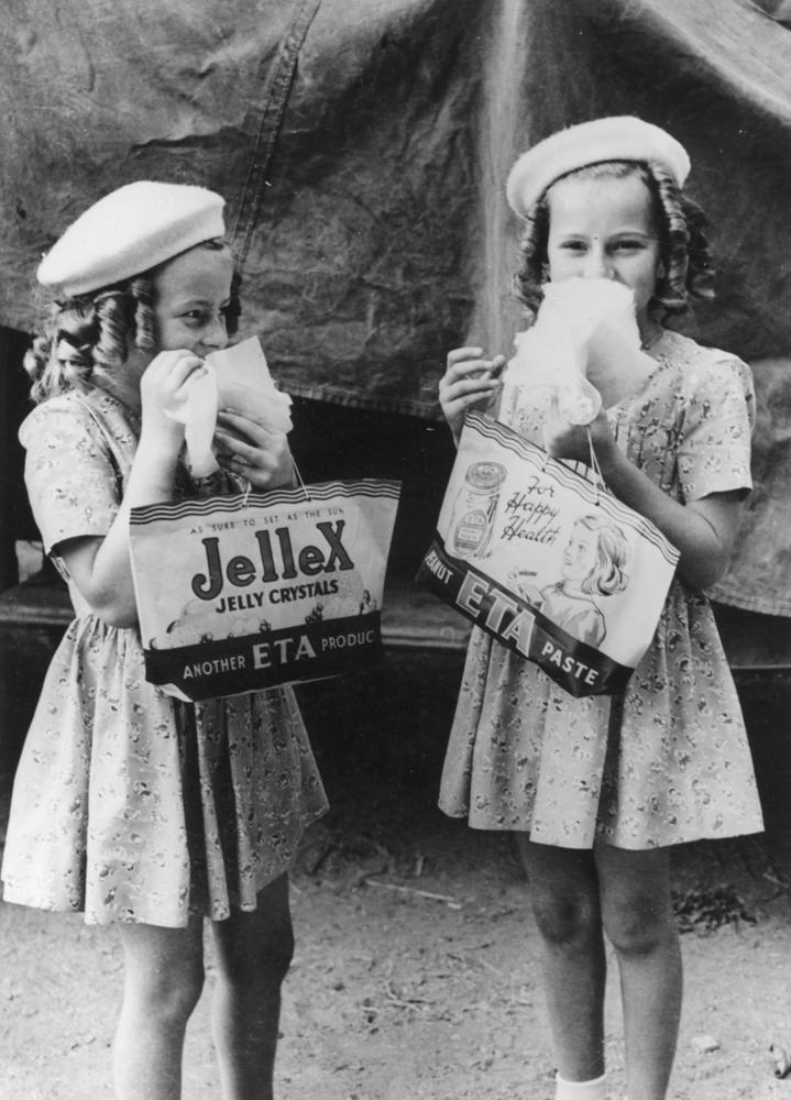 Two young girls enjoying themselves at the RNA Show, Brisbane, 1946