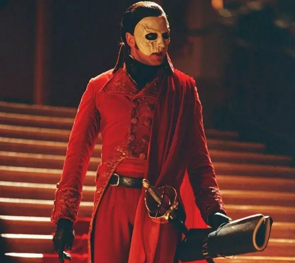 Movie still from Andrew Lloyd Webber's The Phantom of The Opera featuring the "Red Death" masquerade costume