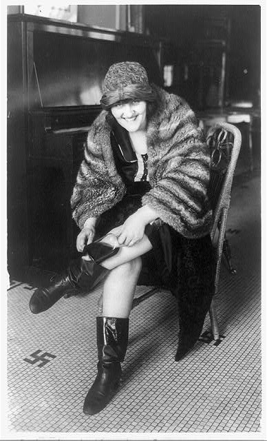 Flapper putting a flask in her boot