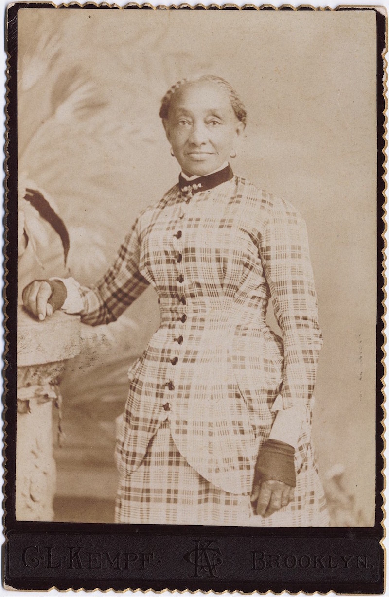 Three quarter length portrait of elderly lady in a plaid dress
