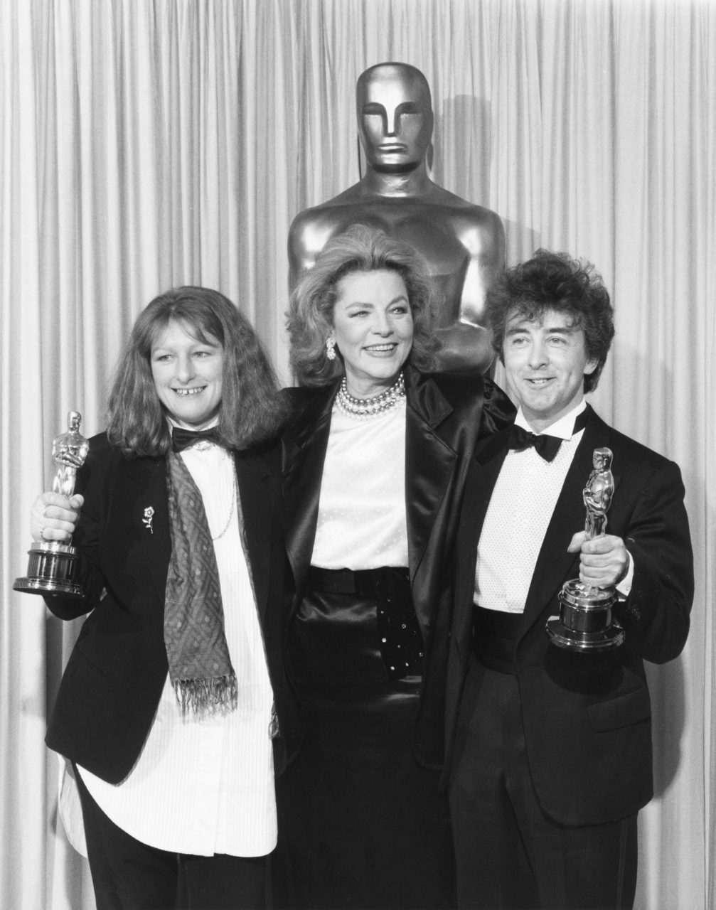 Presenter Lauren Bacall poses with Jenny Beavan and John Bright, who took home the Academy Award for Best Costume Design for their work on A Room With a View (1986)