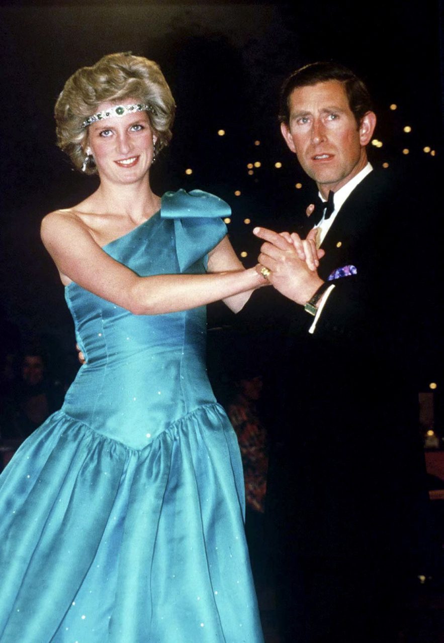 Prince Charles Dancing With His Wife, Princess Diana, In Melbourne, During Their Official Tour Of Australia. The Princess Is Wearing A Diamond And Emerald Choker (a Wedding Gift From The Queen) As A Headband With A One-shouldered Turquoise Satin Organza dress Designed By David And Elizabeth Emanuel