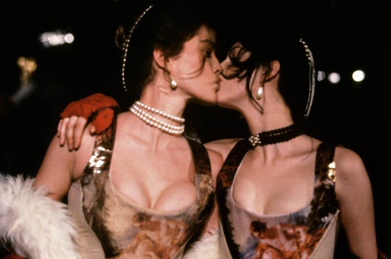 Models kiss as they wear outfits during a fashion show by British designer Vivienne Westwood